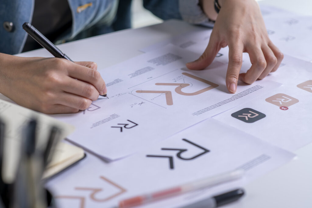Graphic designer drawing sketches logo design. The concept of a new brand. Professional creative occupation with idea.